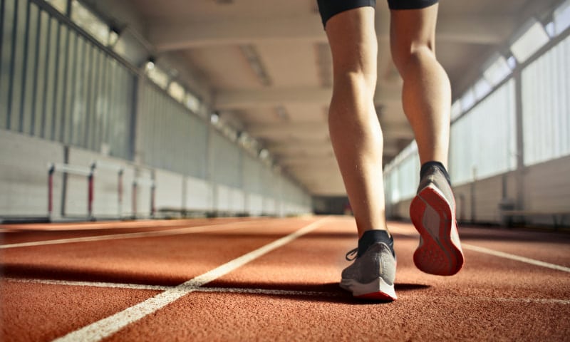 Corredor camina por pista de atletismo